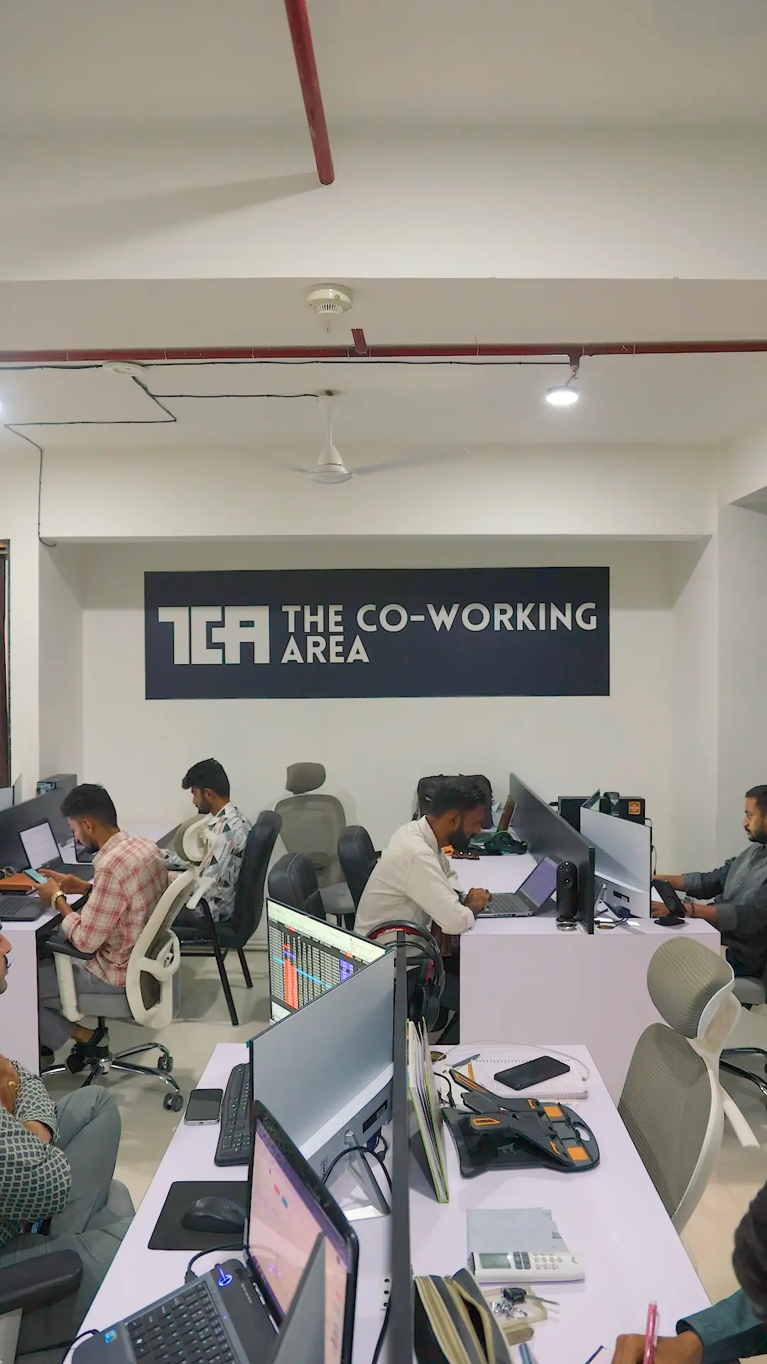 Traders working at multi-screen desks